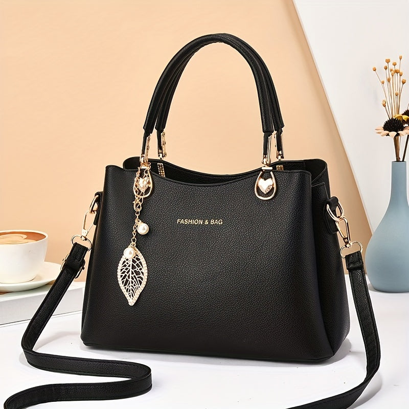 Handtas dames – elegant met gouden details en bedel