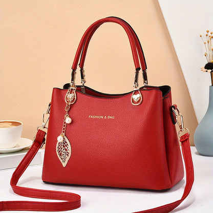 Handtas dames – elegant met gouden details en bedel