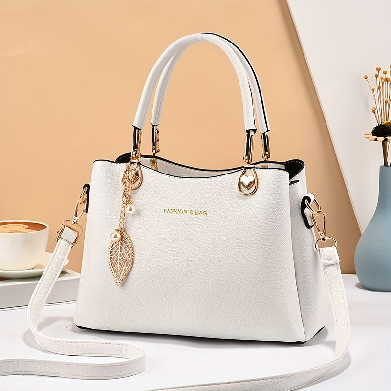Handtas dames – elegant met gouden details en bedel