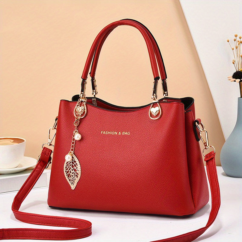 Handtas dames – elegant met gouden details en bedel