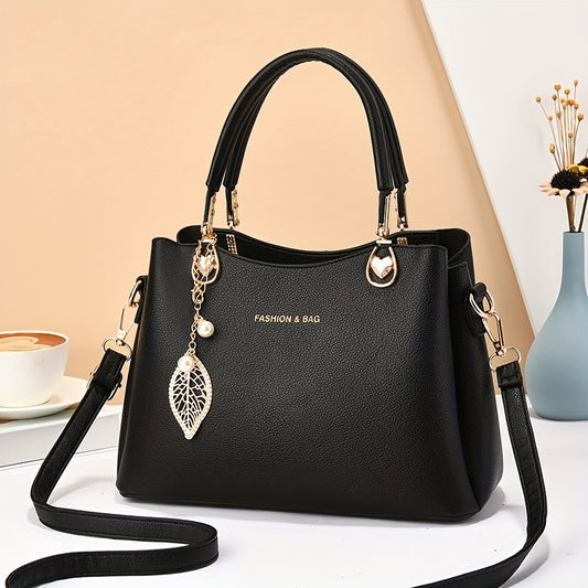 Handtas dames – elegant met gouden details en bedel